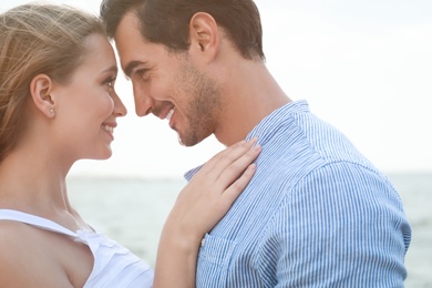 Photo of Happy young couple spending time at sea beach