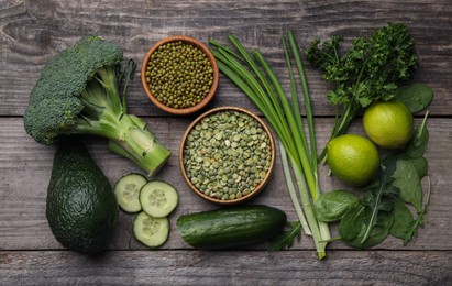 Photo of Different vegetables on wooden table, flat lay. Vegan diet