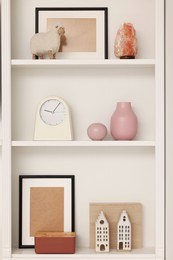 Photo of Shelves with different decor indoors. Interior design