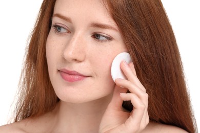 Photo of Beautiful woman with freckles wiping face on white background, closeup