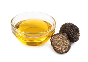Photo of Glass bowl of oil and fresh truffles on white background