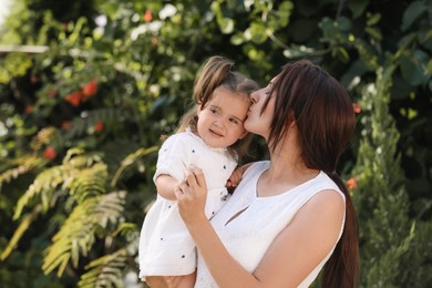 Photo of Mother with her cute daughter spending time together in park