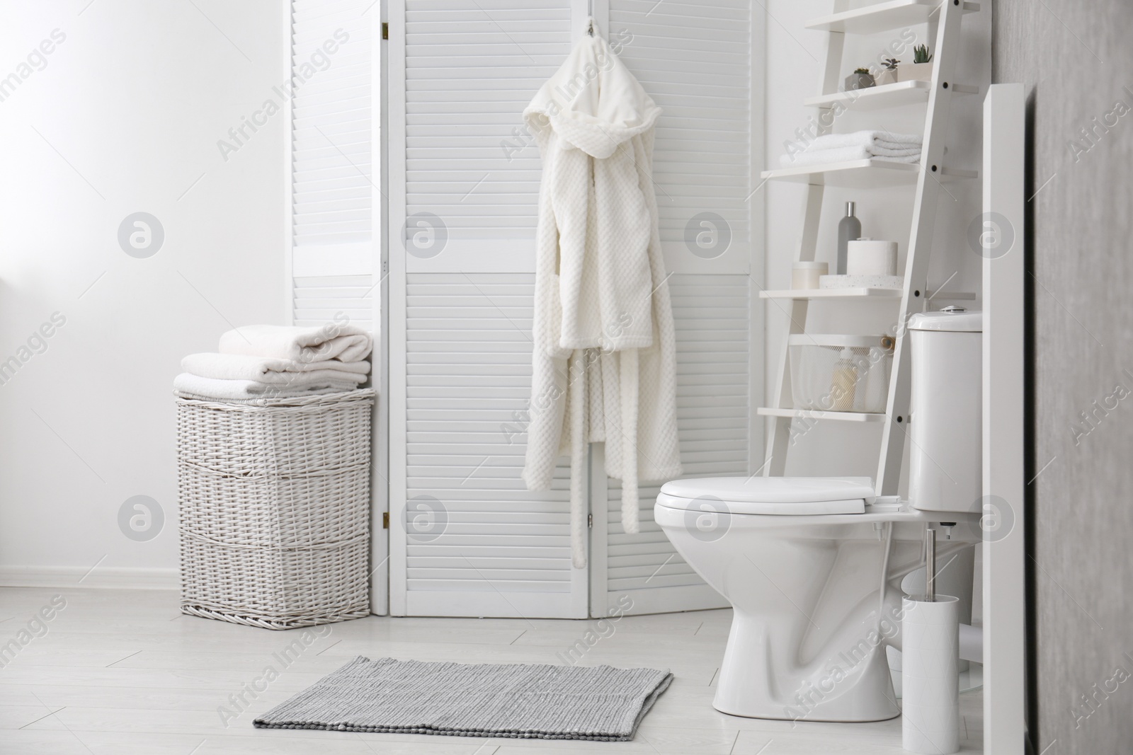 Photo of Ceramic toilet bowl in stylish bathroom. Idea for interior design