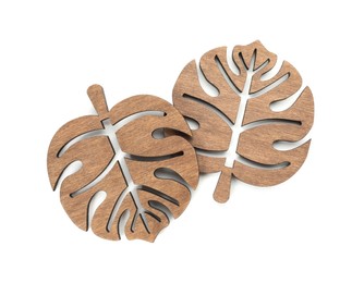 Photo of Leaf shaped wooden cup coasters on white background, top view