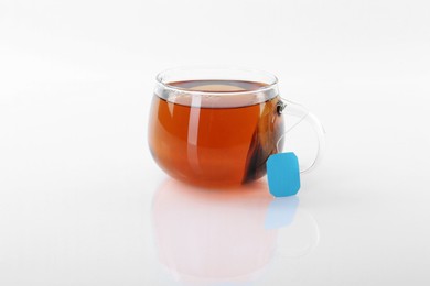 Tasty tea in cup on white background