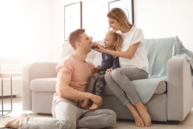 Young pregnant woman with her family at home