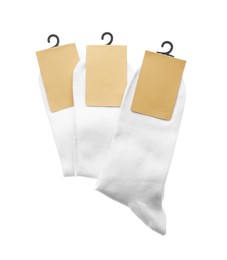 Photo of New pairs of cotton socks on white background, top view