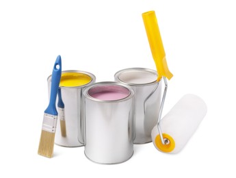 Cans with different paints, brush and roller on white background