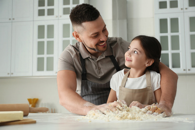 Father and daughter cooking together in kitchen