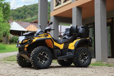 Photo of Modern offroad quad bike near building outdoors