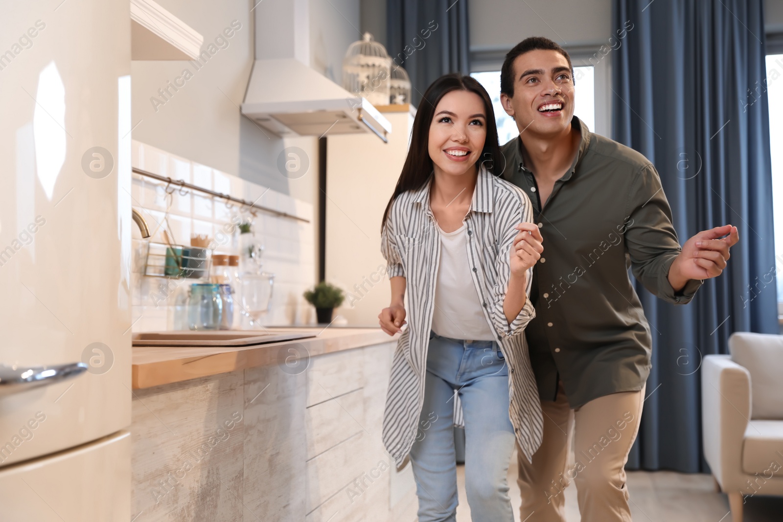 Photo of Lovely young interracial couple dancing at home