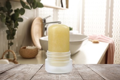 Image of Natural crystal alum deodorant on wooden table in bathroom