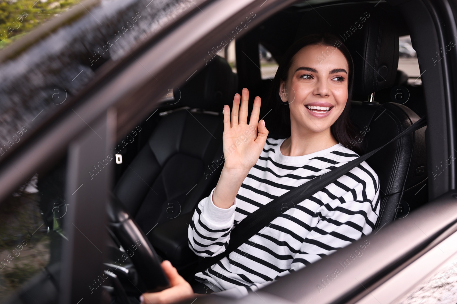 Photo of Woman with safety seat belt driving her modern car