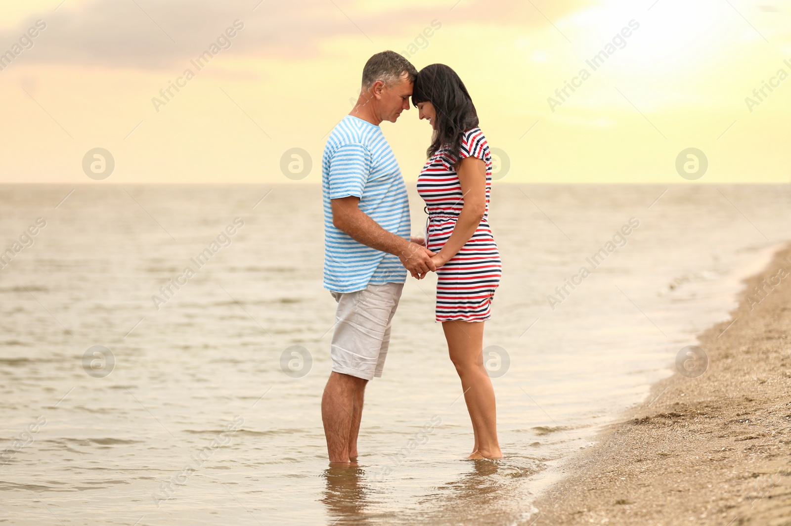 Photo of Happy mature couple spending time together on sea beach