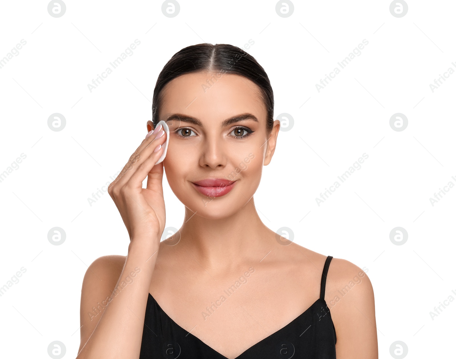 Photo of Beautiful woman removing makeup with cotton pad on white background