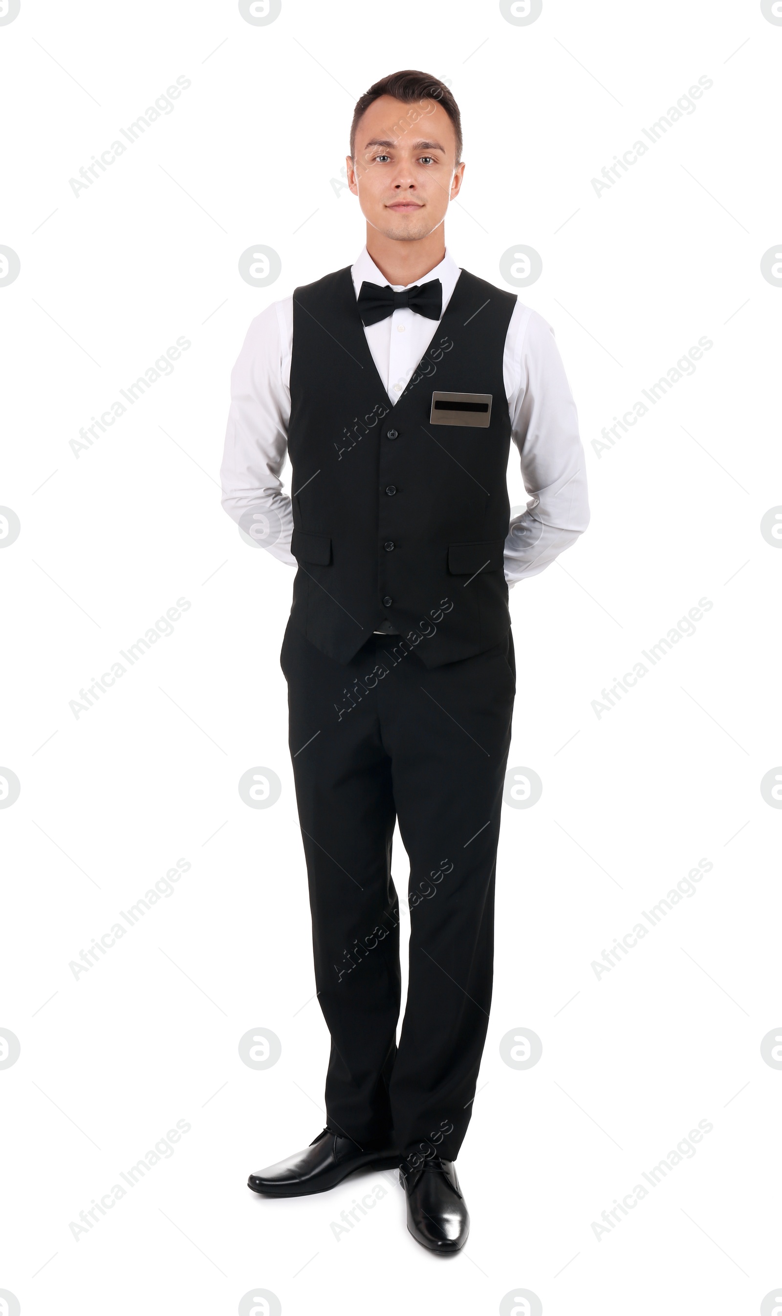 Photo of Full length portrait of young waiter in uniform on white background