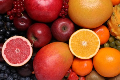 Many different fresh fruits and berries as background, top view