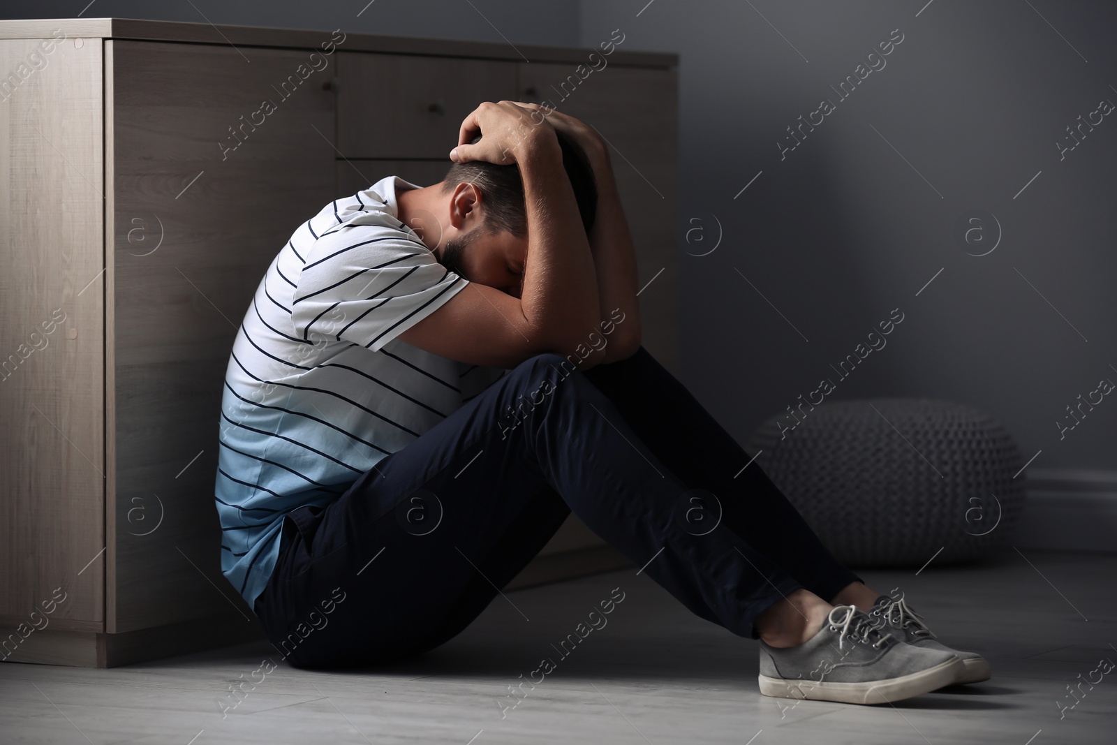 Photo of Lonely man suffering from depression at home