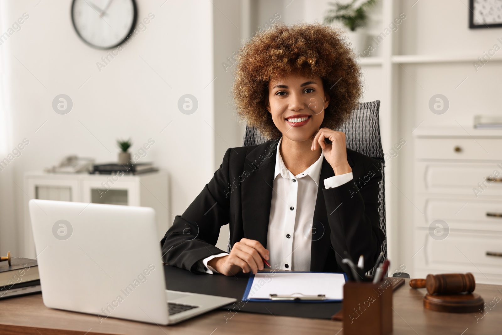 Photo of Notary with clipboard and pen at workplace in office