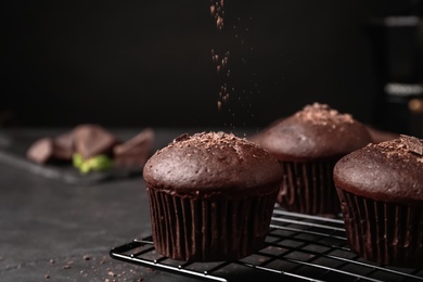 Delicious chocolate muffins on black table, closeup