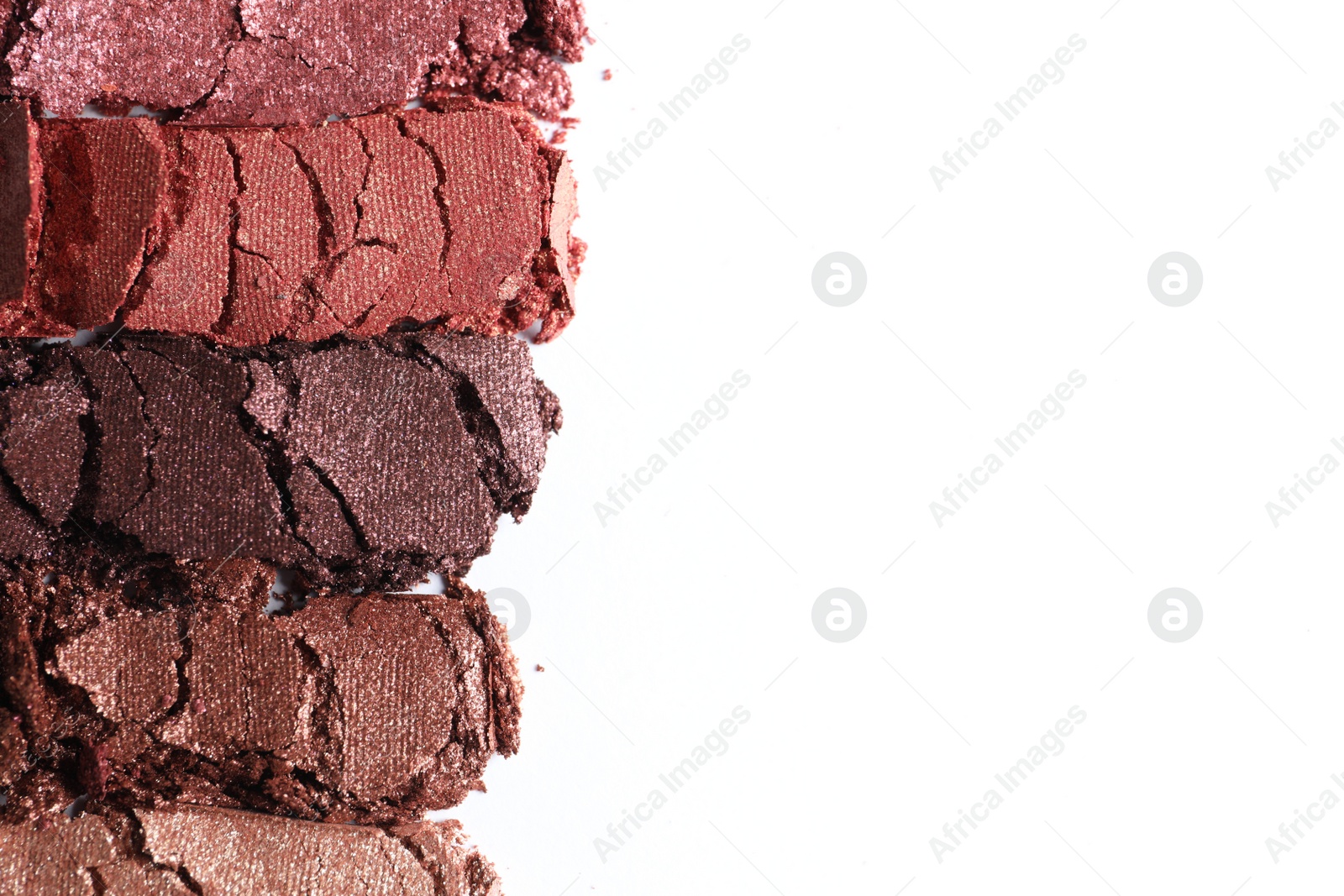 Photo of Different crushed eye shadows on white background, top view. Space for text