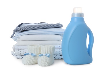 Detergent and children's clothes on white background