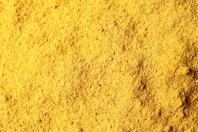 Dry curry powder as background, top view