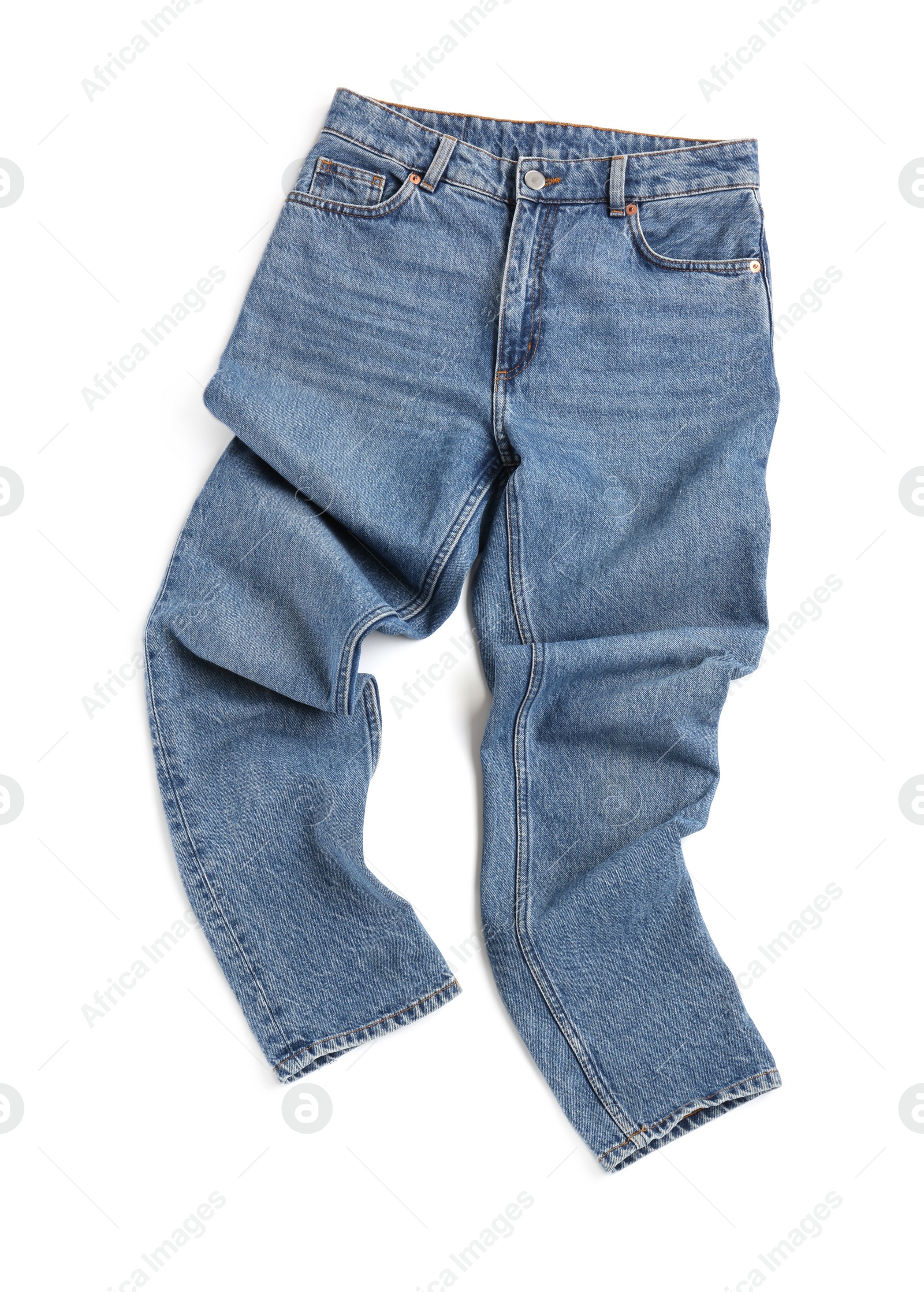 Photo of Rumpled blue jeans isolated on white, top view. Stylish clothes