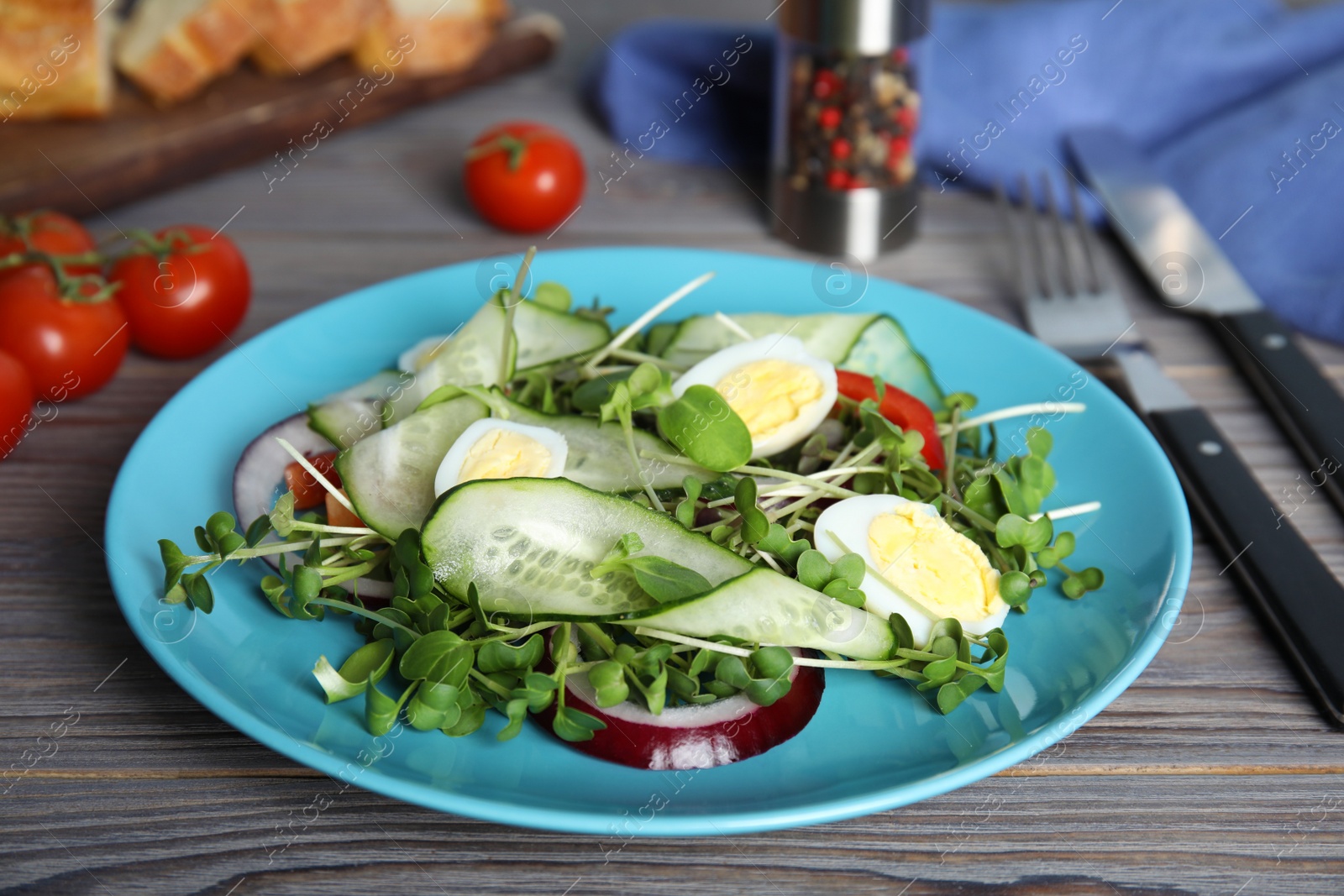 Photo of Salad with fresh organic microgreen in plate on wooden table, closeup