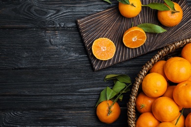 Flat lay composition with fresh ripe tangerines and space for text on wooden background