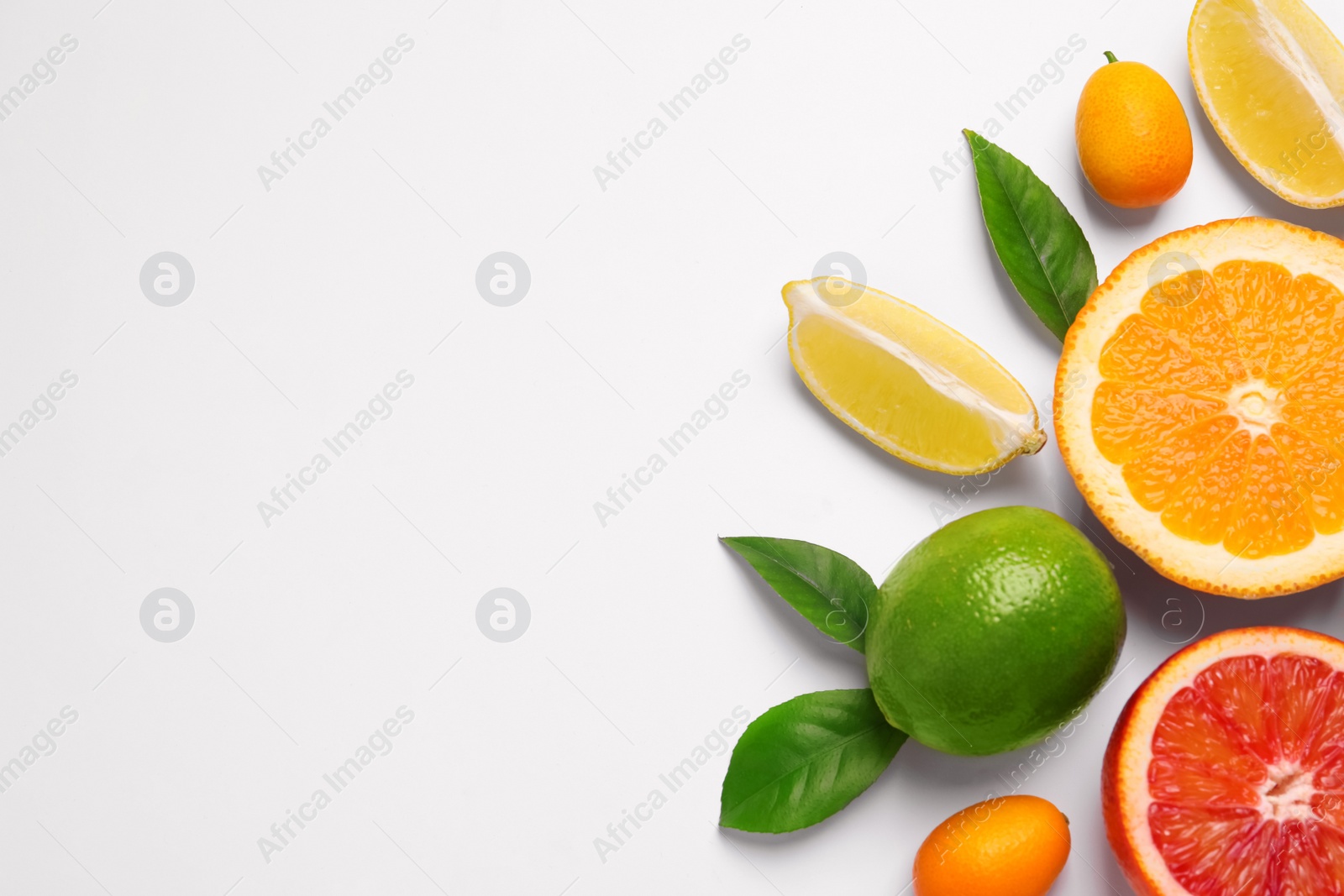 Photo of Fresh juicy citrus fruits with green leaves on light background, flat lay. Space for text