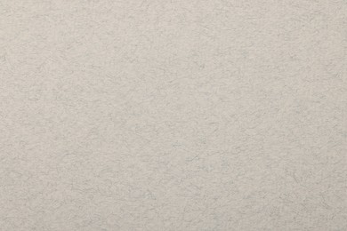 Photo of Texture of light grey paper sheet as background, top view