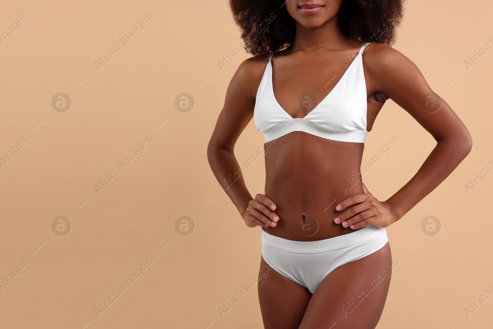Photo of Woman in stylish bikini on beige background, closeup. Space for text