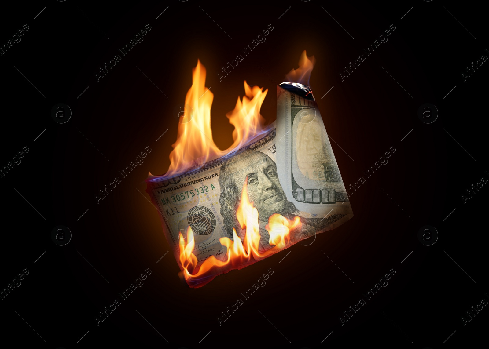 Image of One hundred dollar banknote burning on black background