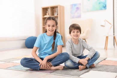 Photo of Happy brother and sister spending time together at home