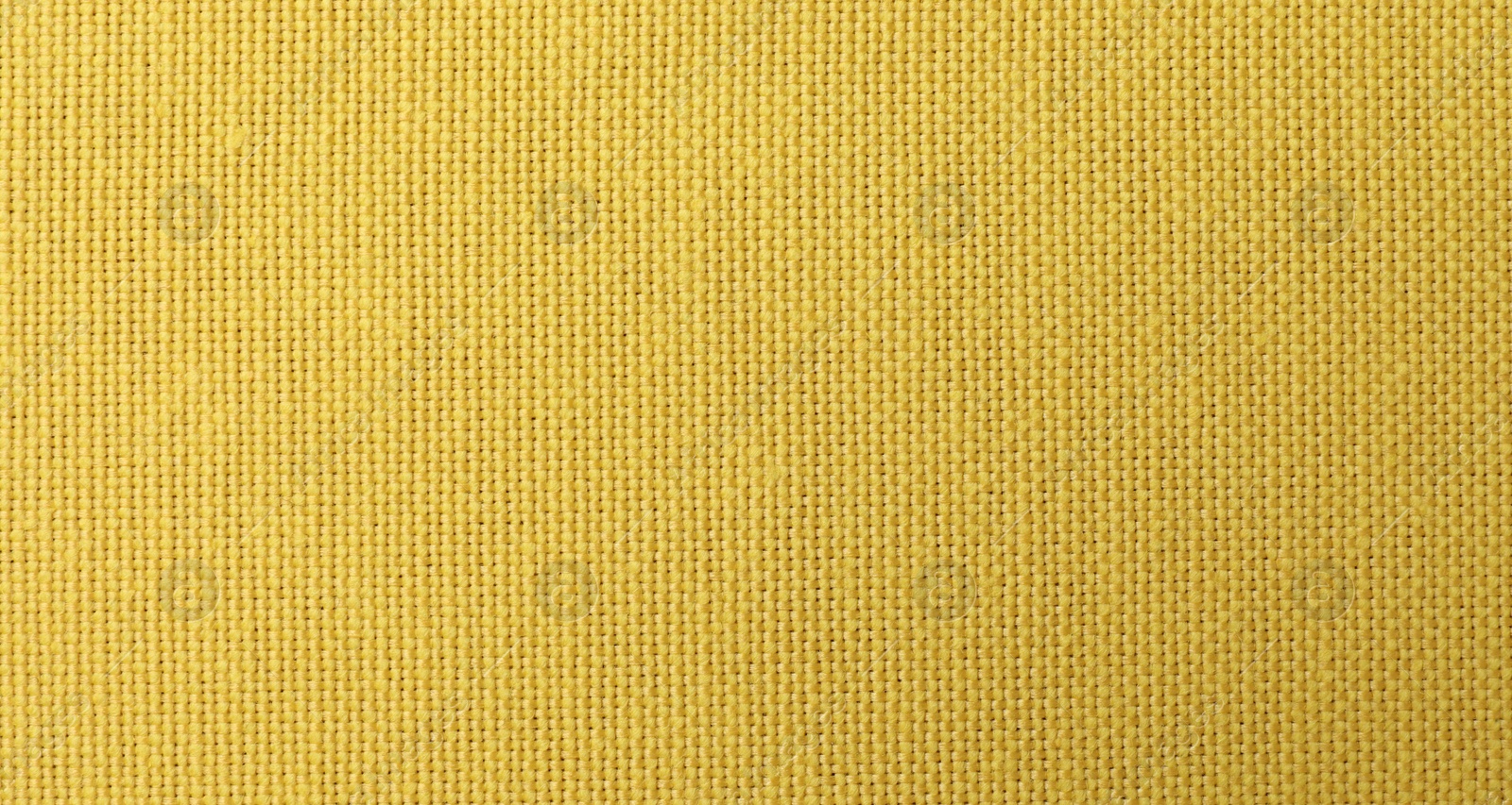 Photo of Texture of yellow fabric as background, top view
