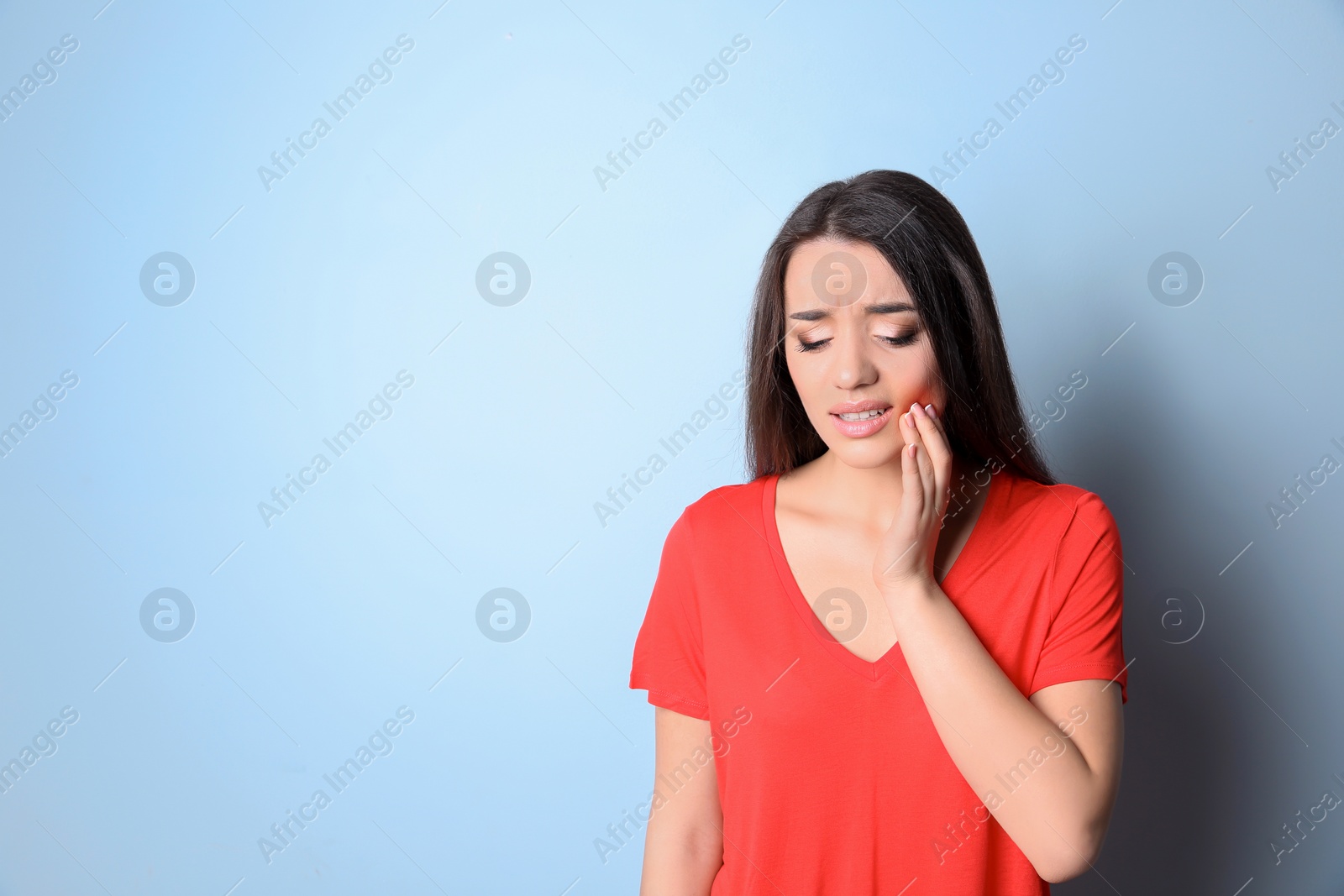 Photo of Woman with sensitive teeth on color background