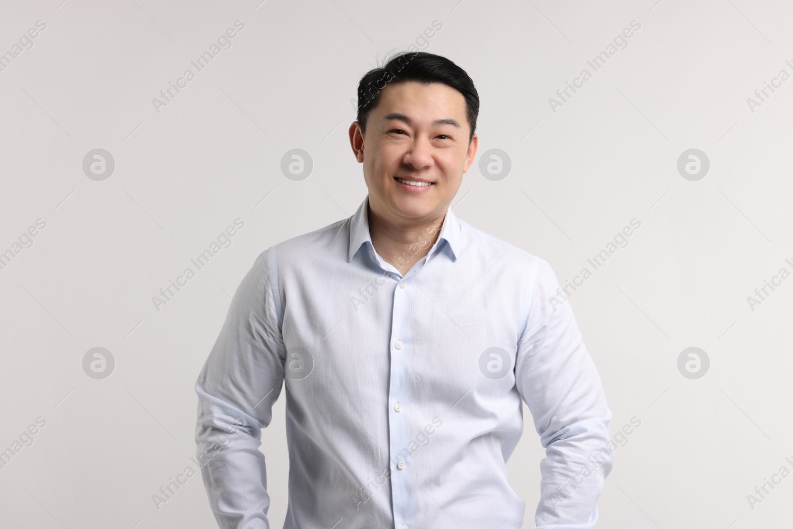 Photo of Portrait of happy man on light background