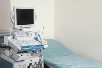 Ultrasound machine and examination table in hospital. Space for text