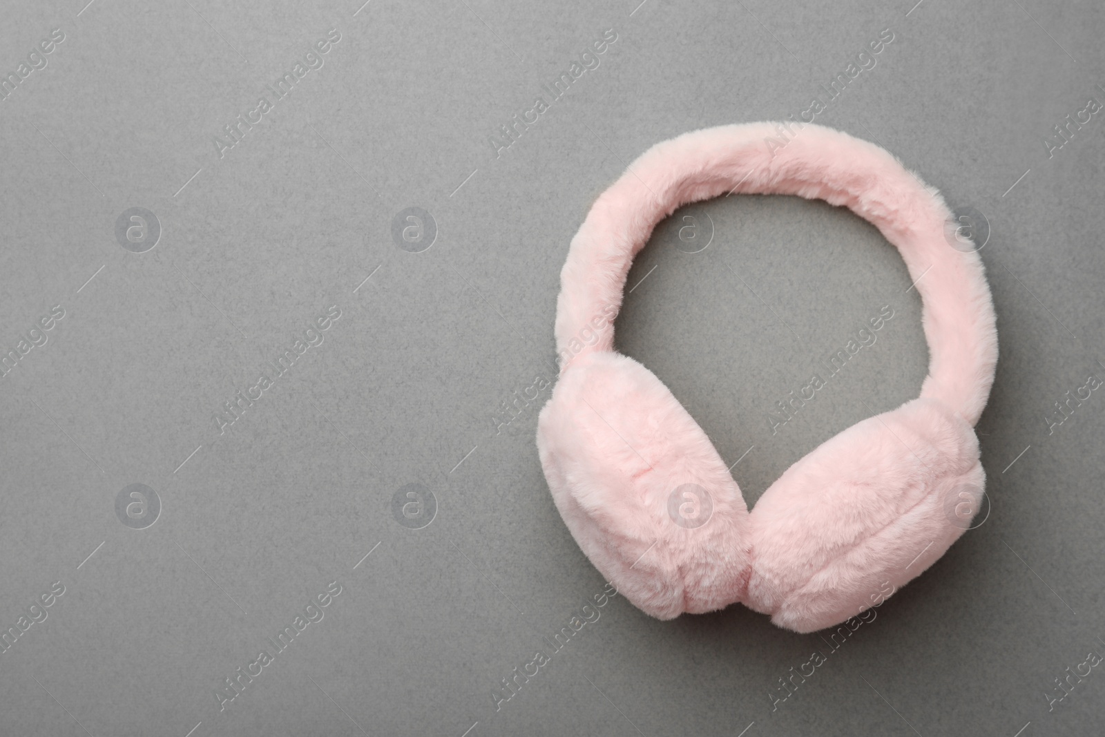 Photo of Stylish winter earmuffs on grey background, top view. Space for text