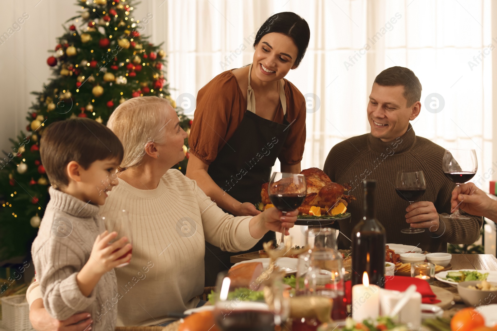 Photo of Happy family enjoying festive dinner at home. Christmas celebration