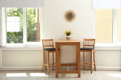 Modern room interior with wooden dining table