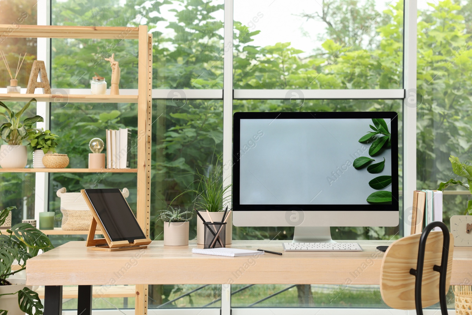 Photo of Comfortable workplace with computer in light room. Interior design