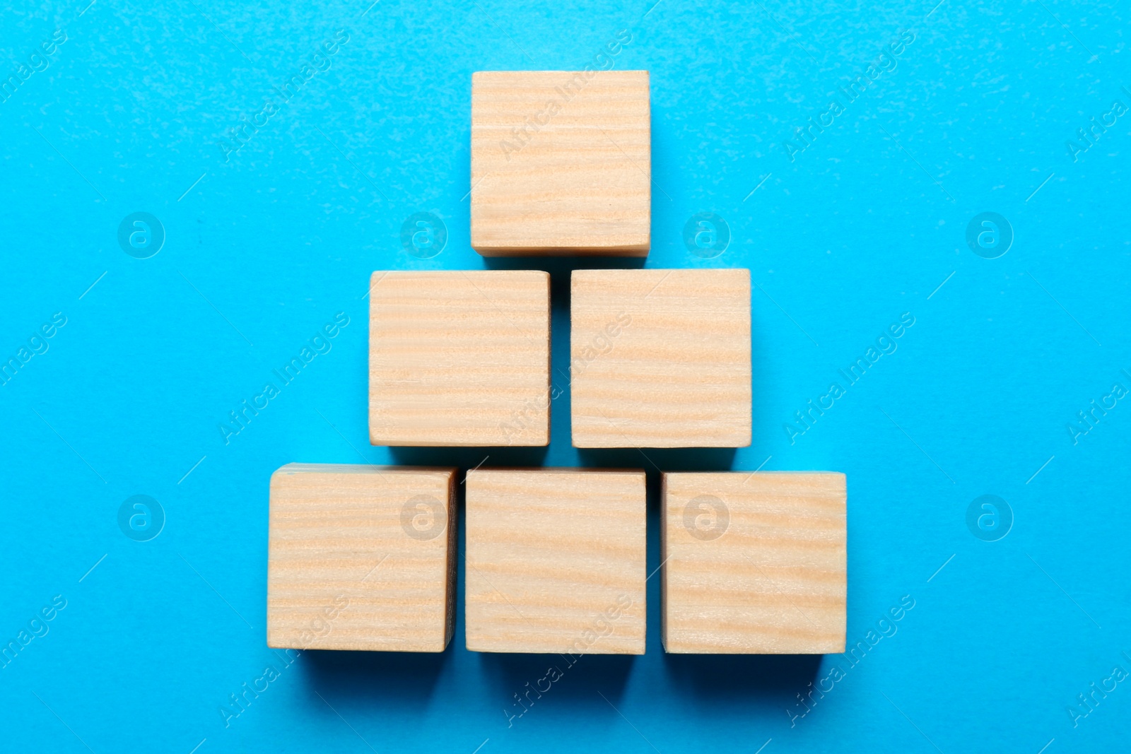 Photo of Blank cubes on light blue background, flat lay with space for text. Idea concept