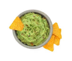 Photo of Bowl of delicious guacamole and nachos chips isolated on white, top view