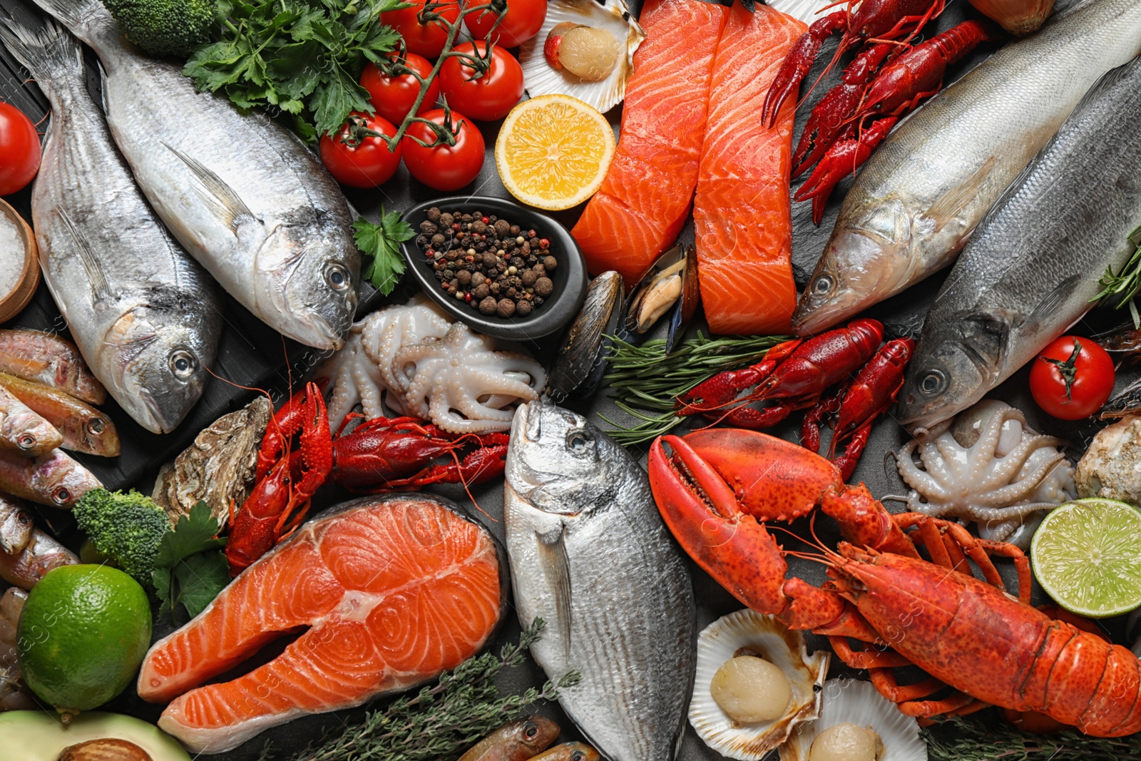 Photo of Fresh fish and different seafood on table, flat lay