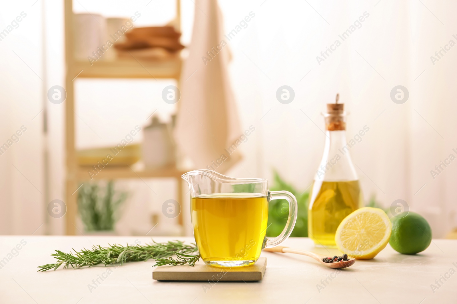 Photo of Composition with fresh rosemary oil on table