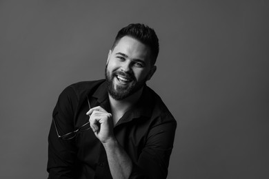 Photo of Portrait of handsome bearded man on grey background, space for text. Black and white effect