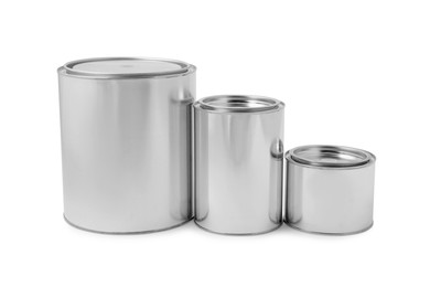 Photo of New metal paint cans on white background