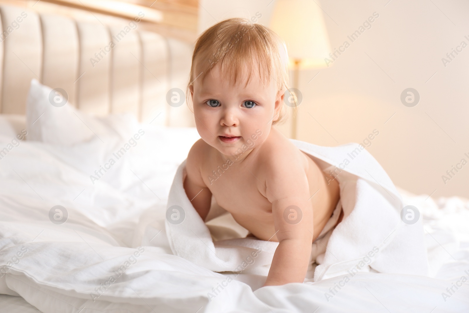 Photo of Cute little baby on bed after bath